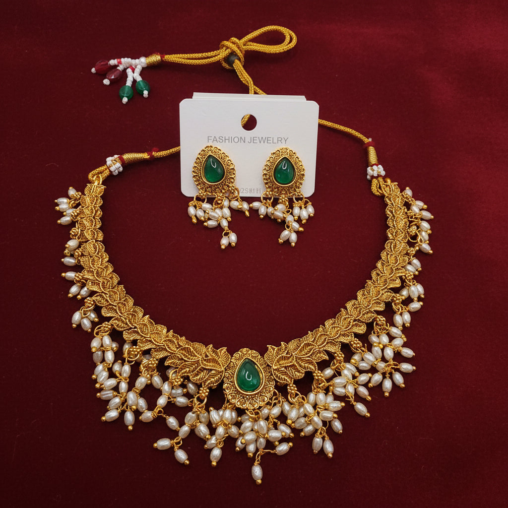 Antique Dull-Gold Finish Guttapusalu Choker Set with Green Stones and Pearl Hangings.